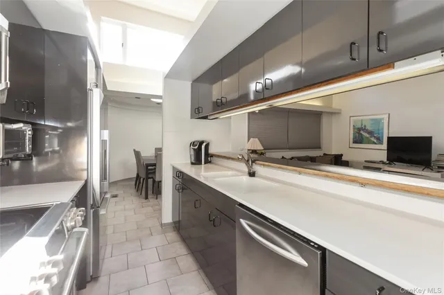 a kitchen with stainless steel appliances a sink stove and cabinets