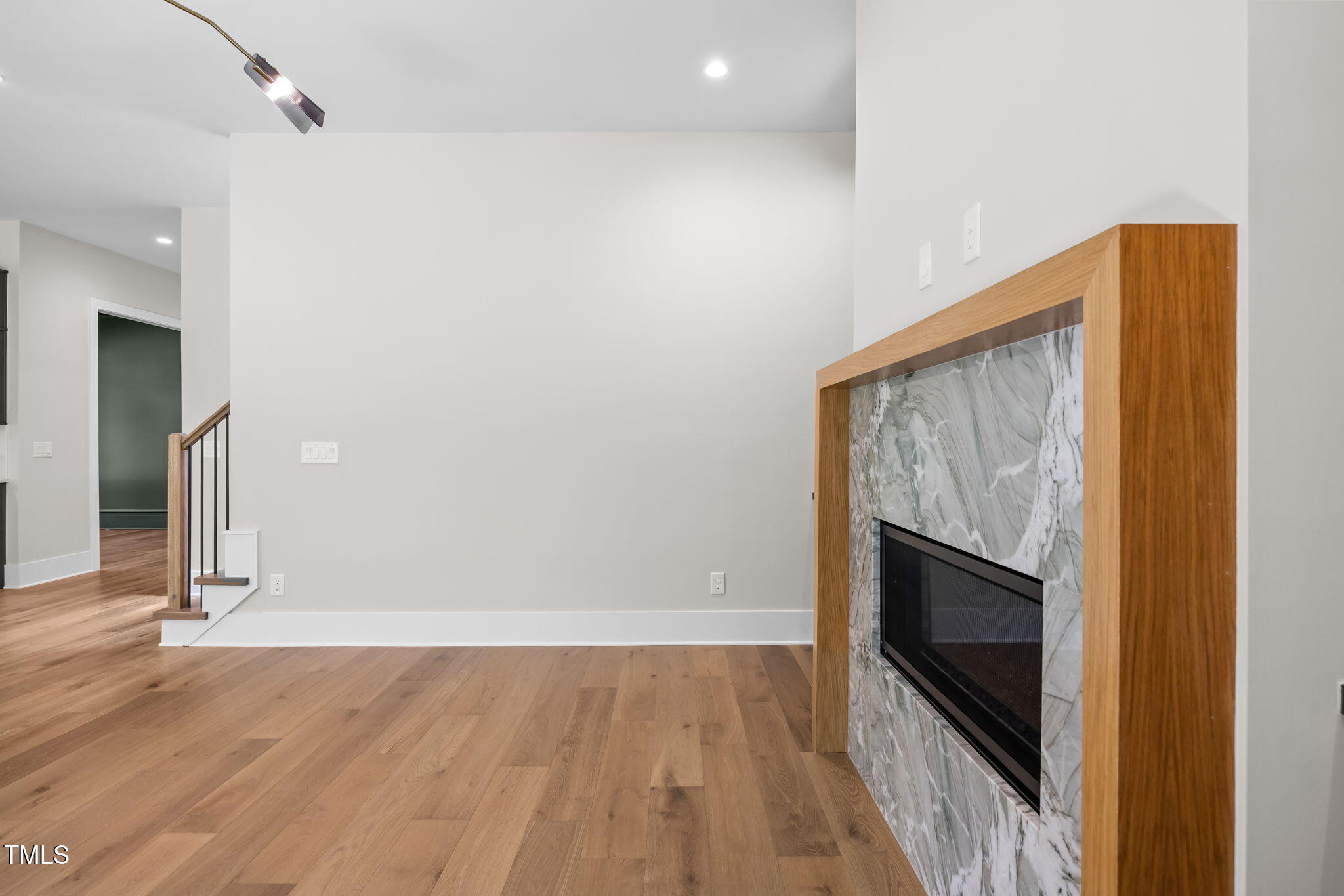 2321 Turners Alley Raleigh, NC 27607 - Photo 20 of 43 a view of an empty room with wooden floor and a fireplace