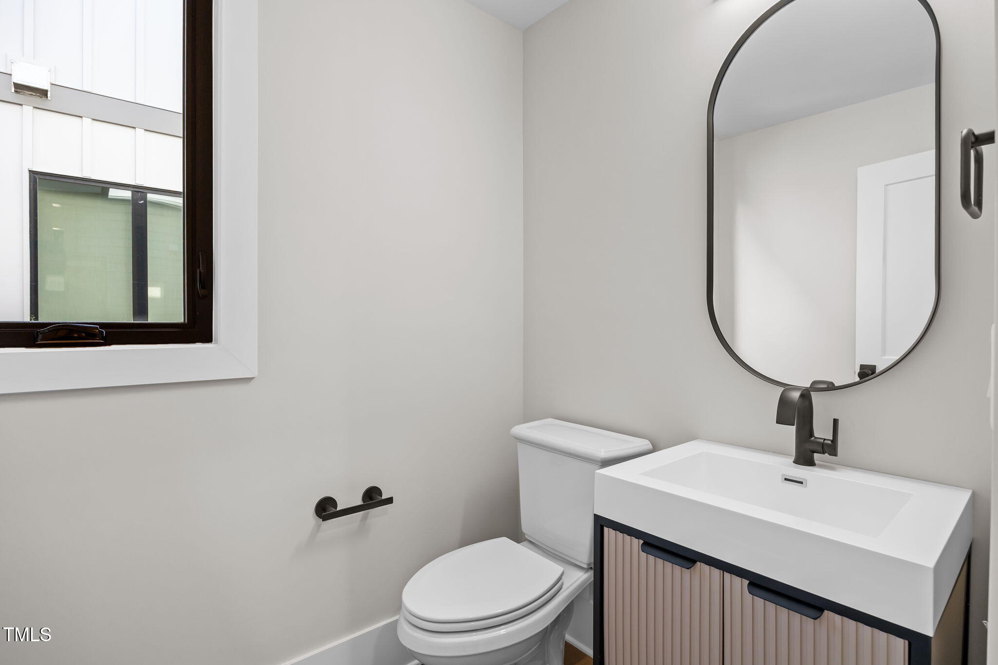 2321 Turners Alley Raleigh, NC 27607 - Photo 24 of 43 a bathroom with a toilet a sink and a mirror