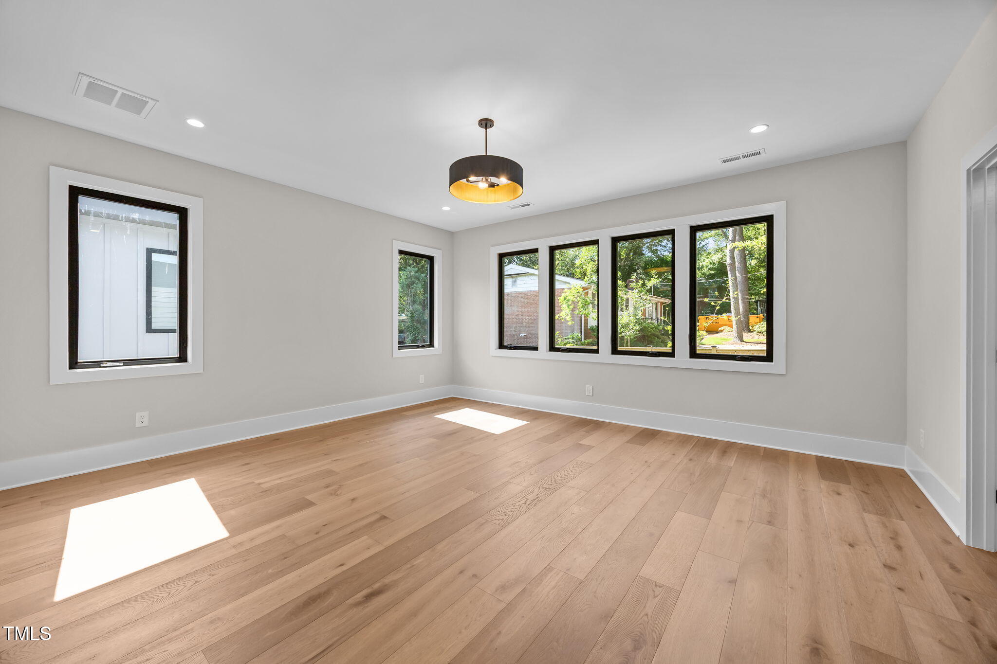 2321 Turners Alley Raleigh, NC 27607 - Photo 30 of 43 a view of an empty room with wooden floor and a window