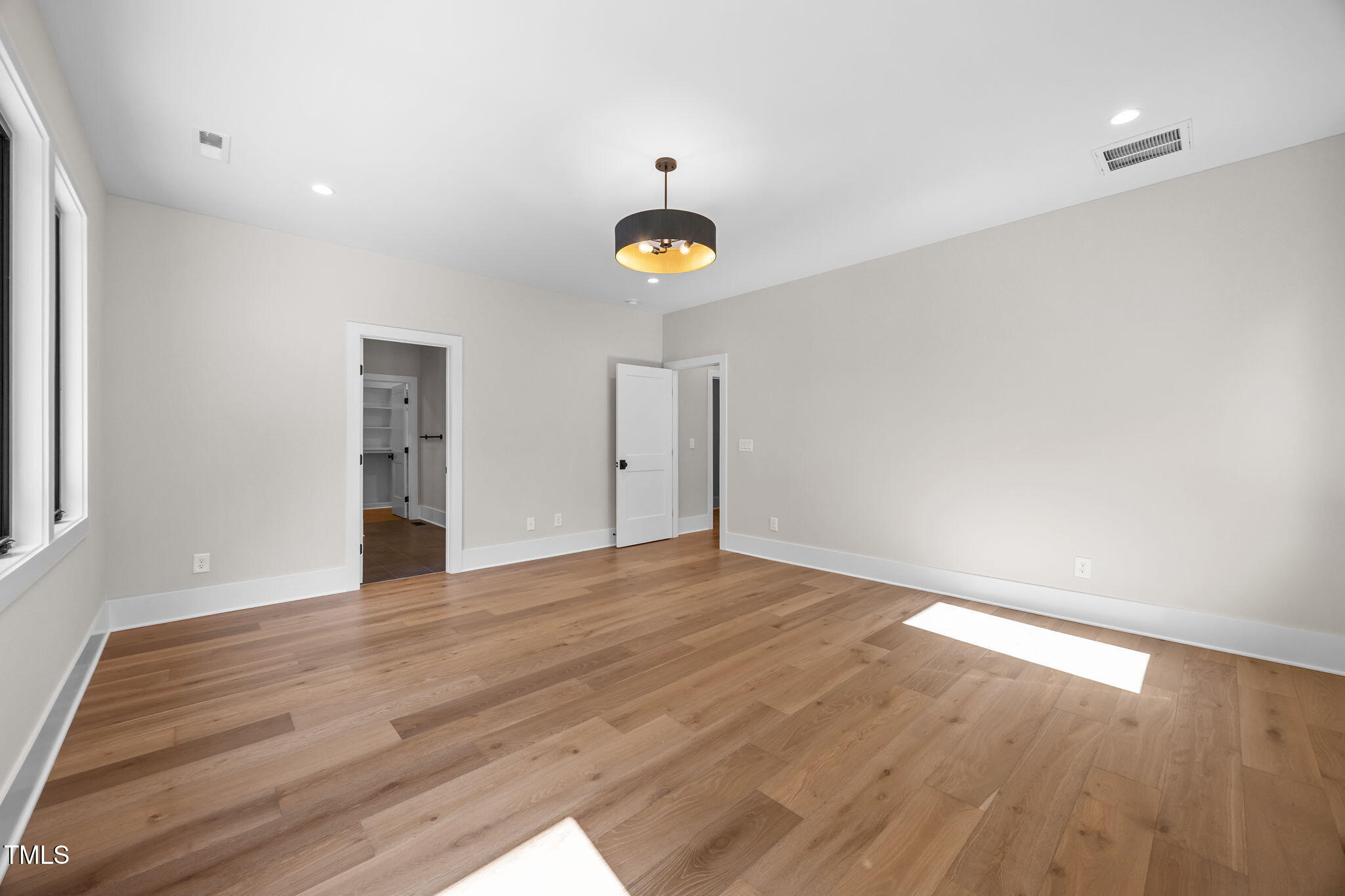 2321 Turners Alley Raleigh, NC 27607 - Photo 31 of 43 a view of an empty room with wooden floor and windows
