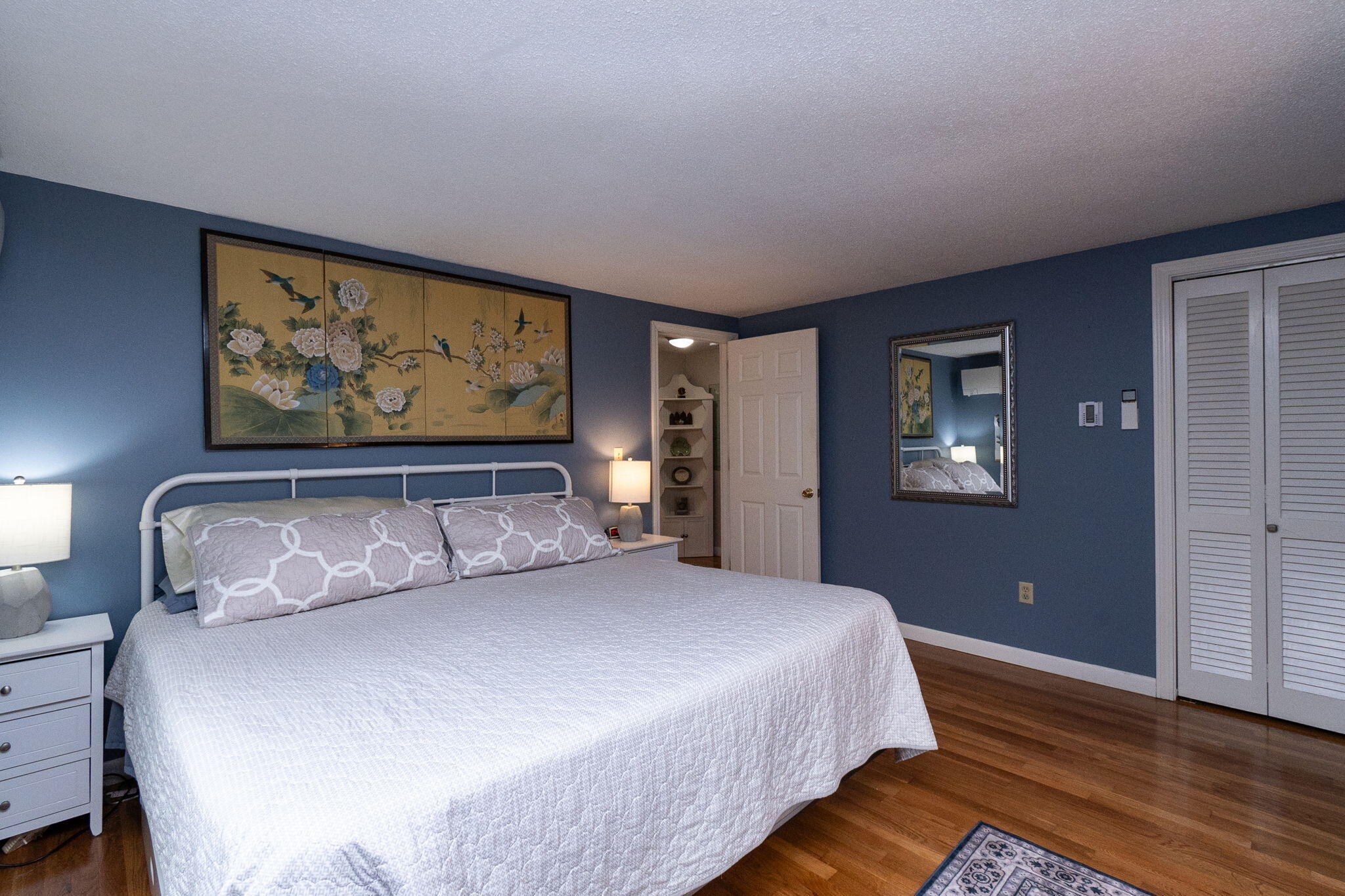 102 Sea Street Dennis Port, MA 02639 - Photo 16 of 37 a bedroom with a large bed and a painting on the wall