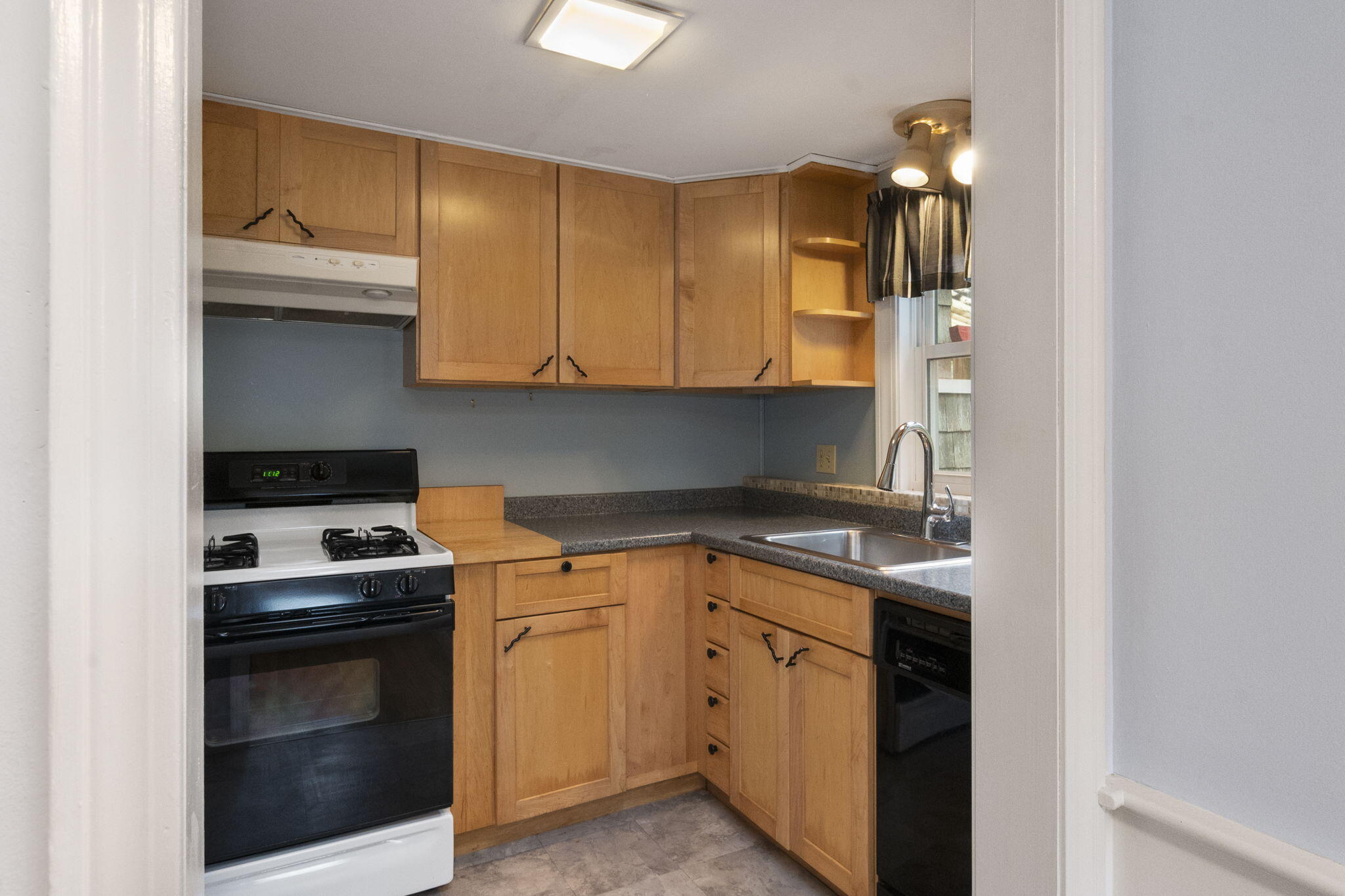 102 Sea Street Dennis Port, MA 02639 - Photo 27 of 37 a kitchen with a sink and a stove top oven