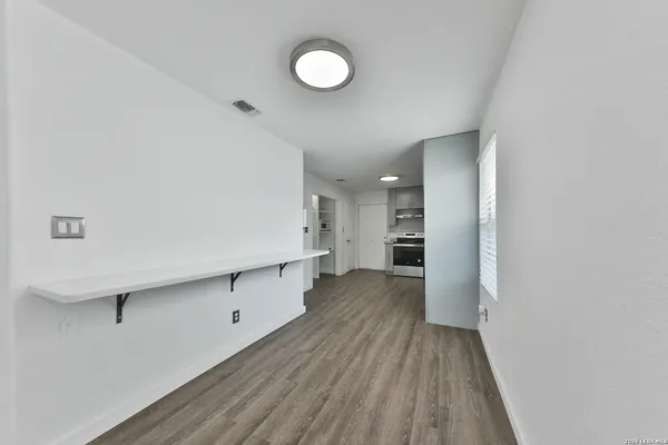 a view of a kitchen with wooden floor and a sink
