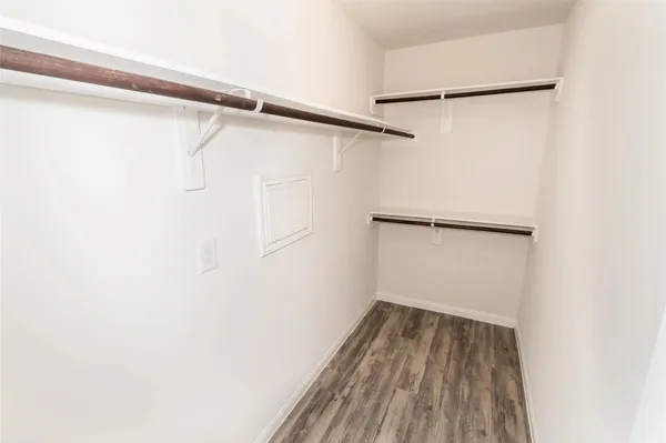 a view of a room with wooden floor and a window