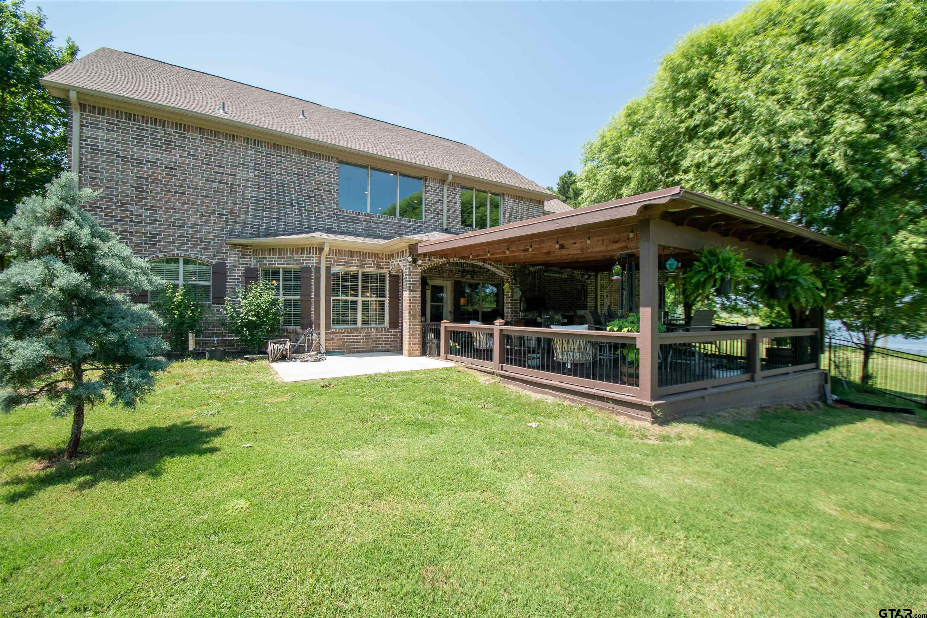 23120 Saddle Ridge Court Lindale, TX 75771 - Photo 27 of 34 a view of a house with a yard patio and a garden