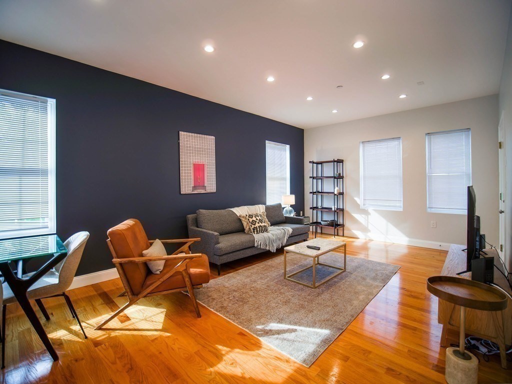 309 R Sumner Street, Unit 3 Boston, MA 02128 - Photo 1 of 16 a living room with furniture and a flat screen tv