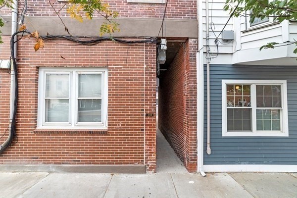 309 R Sumner Street, Unit 3 Boston, MA 02128 - Photo 15 of 16 a view of a brick house with large windows