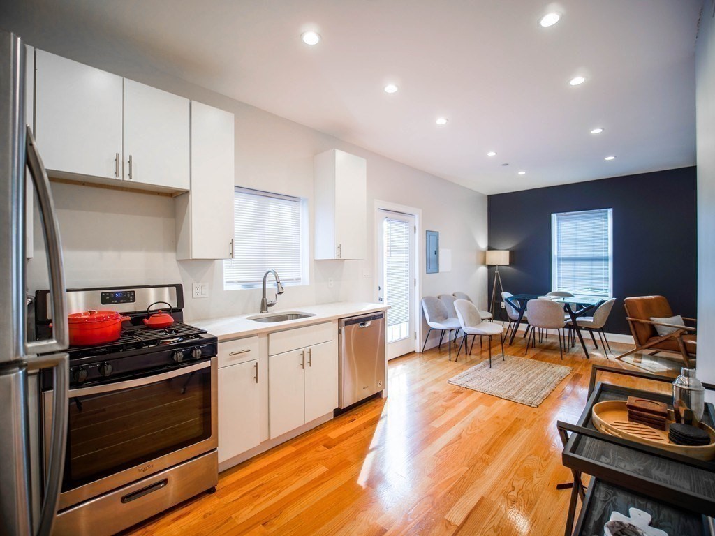 309 R Sumner Street, Unit 3 Boston, MA 02128 - Photo 2 of 16 a open kitchen with stainless steel appliances granite countertop a stove and white cabinets