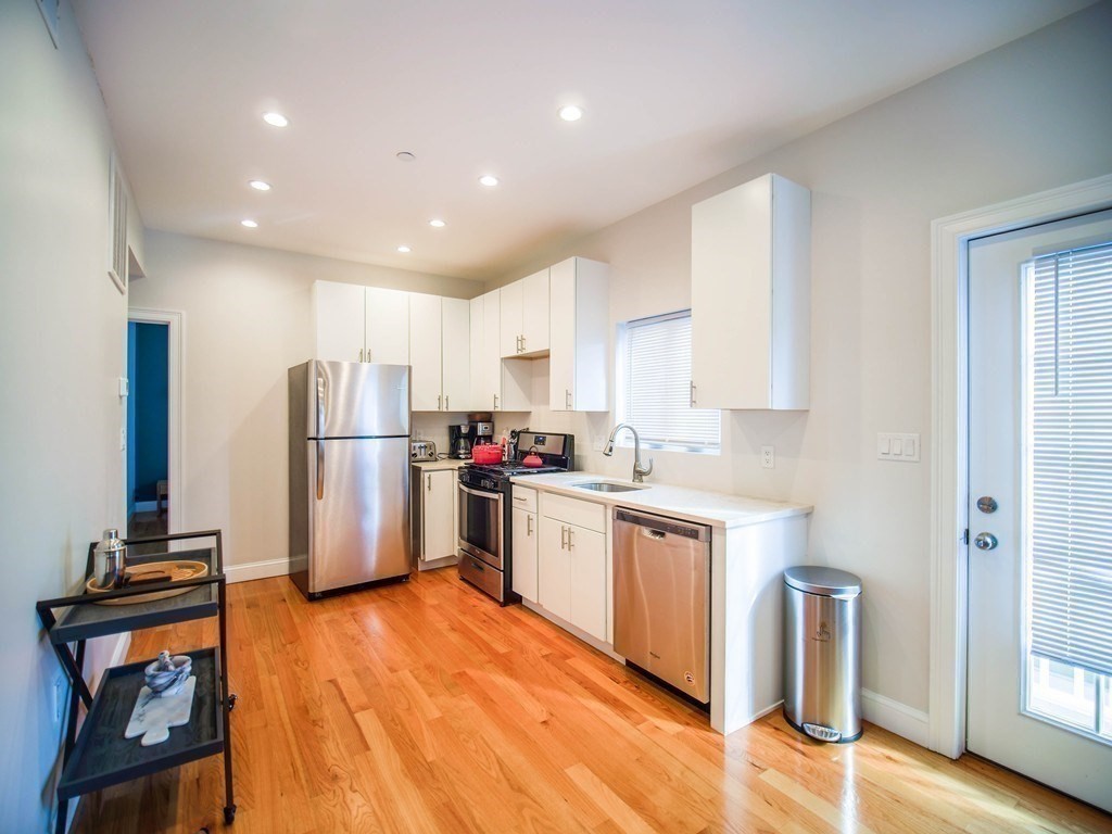 309 R Sumner Street, Unit 3 Boston, MA 02128 - Photo 3 of 16 a kitchen with stainless steel appliances granite countertop a refrigerator and a stove top oven