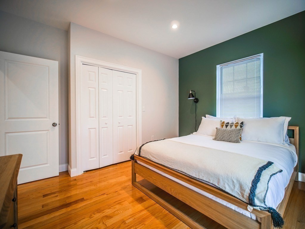 309 R Sumner Street, Unit 3 Boston, MA 02128 - Photo 4 of 16 a bedroom with a bed and wooden floor
