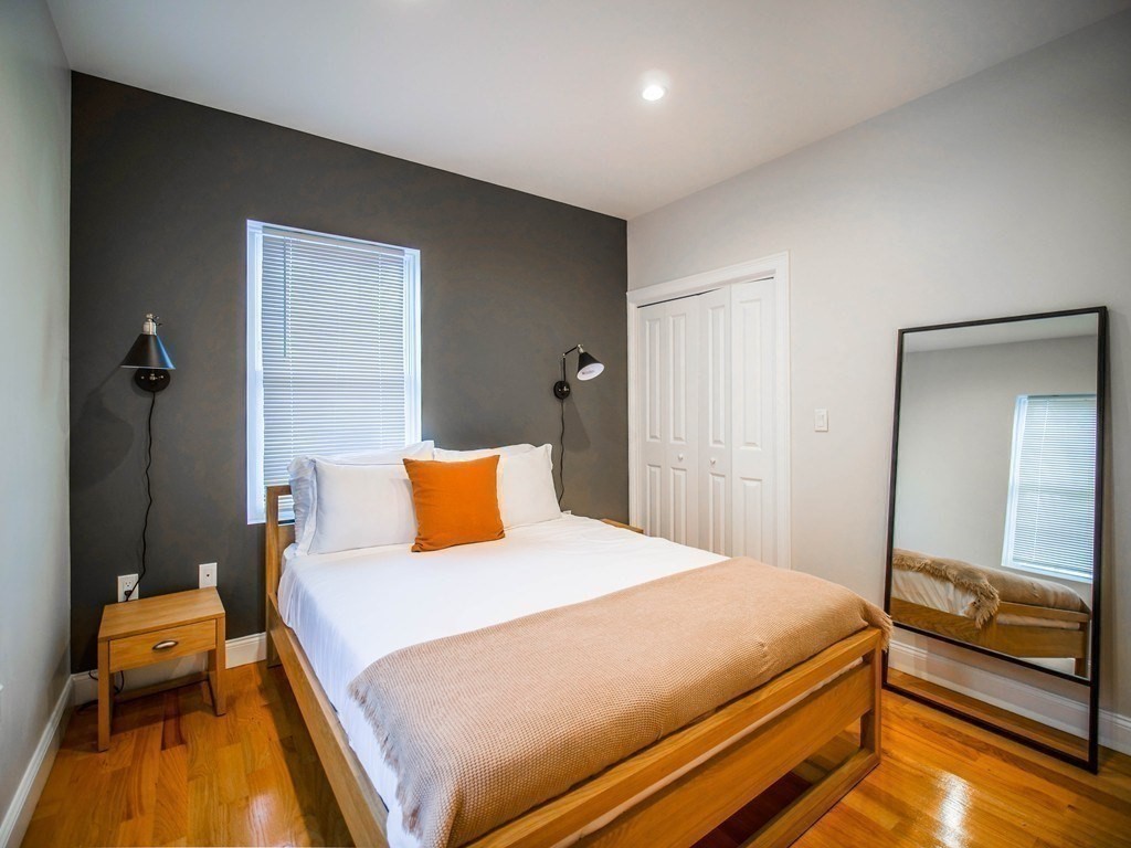 309 R Sumner Street, Unit 3 Boston, MA 02128 - Photo 6 of 16 a bedroom with a bed and wooden floor