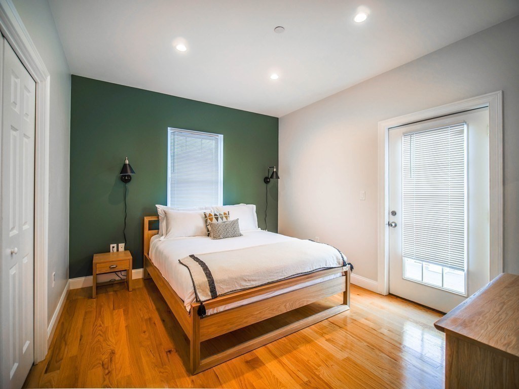 309 R Sumner Street, Unit 3 Boston, MA 02128 - Photo 7 of 16 a bedroom with a bed and wooden floor