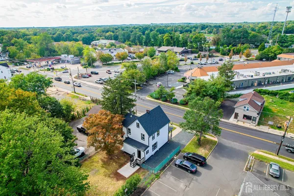 an aerial view of a house with a garden and lake view