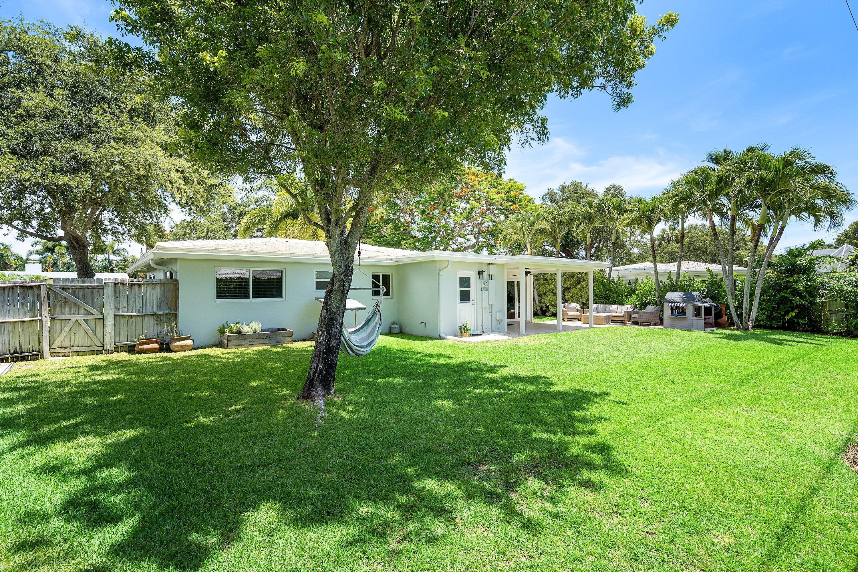 774 Southwest 7th Street Boca Raton, FL 33486 - Photo 25 of 28 a front view of house with yard and green space