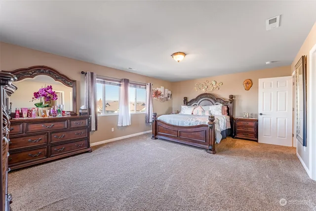 a bedroom with furniture and a dresser