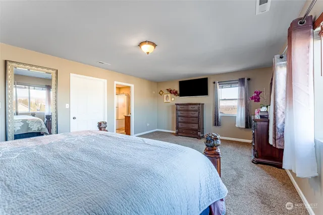 a bed room with a bed and a tv