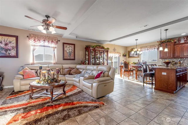 a living room with furniture and a chandelier