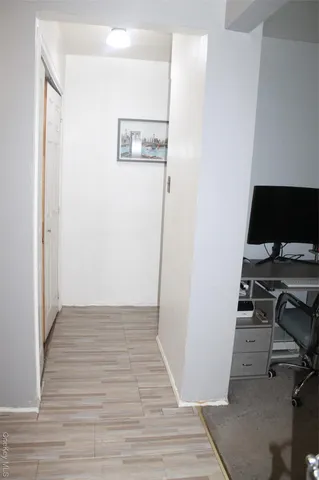 a view of a workspace with wooden floor