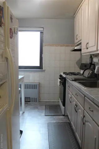 a kitchen with stainless steel appliances a stove a sink and a refrigerator