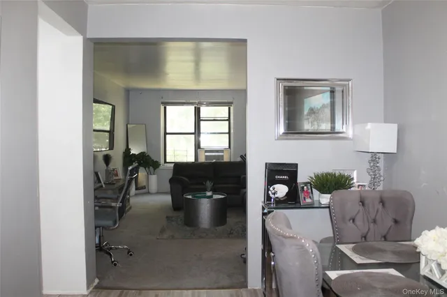 a living room with furniture a fireplace and potted plants