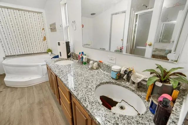 a bathroom with a granite countertop sink and a mirror