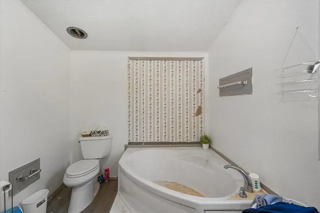 a white toilet sitting next to a bathroom sink