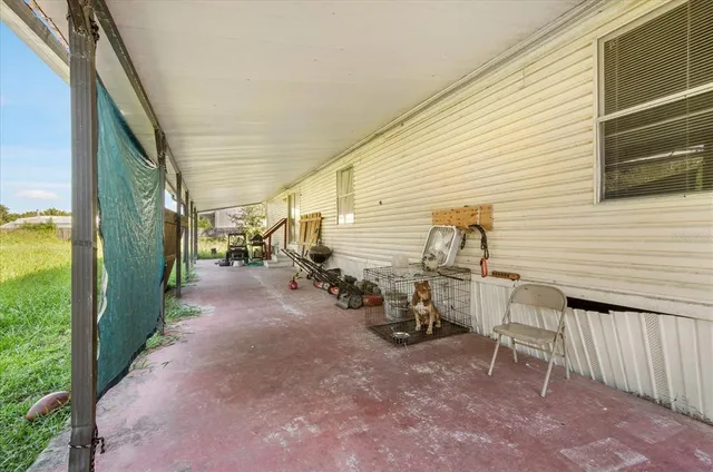 a view of a patio with table and chairs and couches