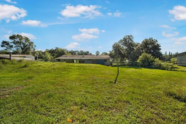 a view of a garden with a building in the background