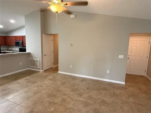 a view of kitchen with a sink cabinets and window