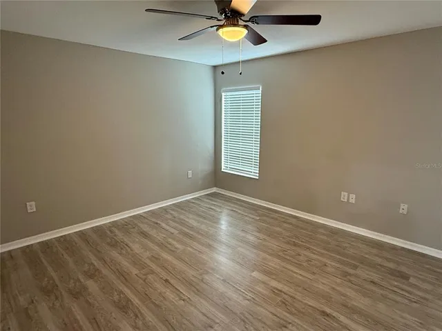 wooden floor in an empty room with a window