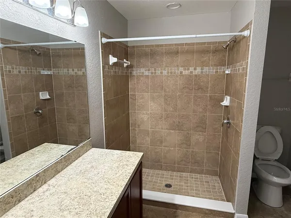 a bathroom with a shower and toilet