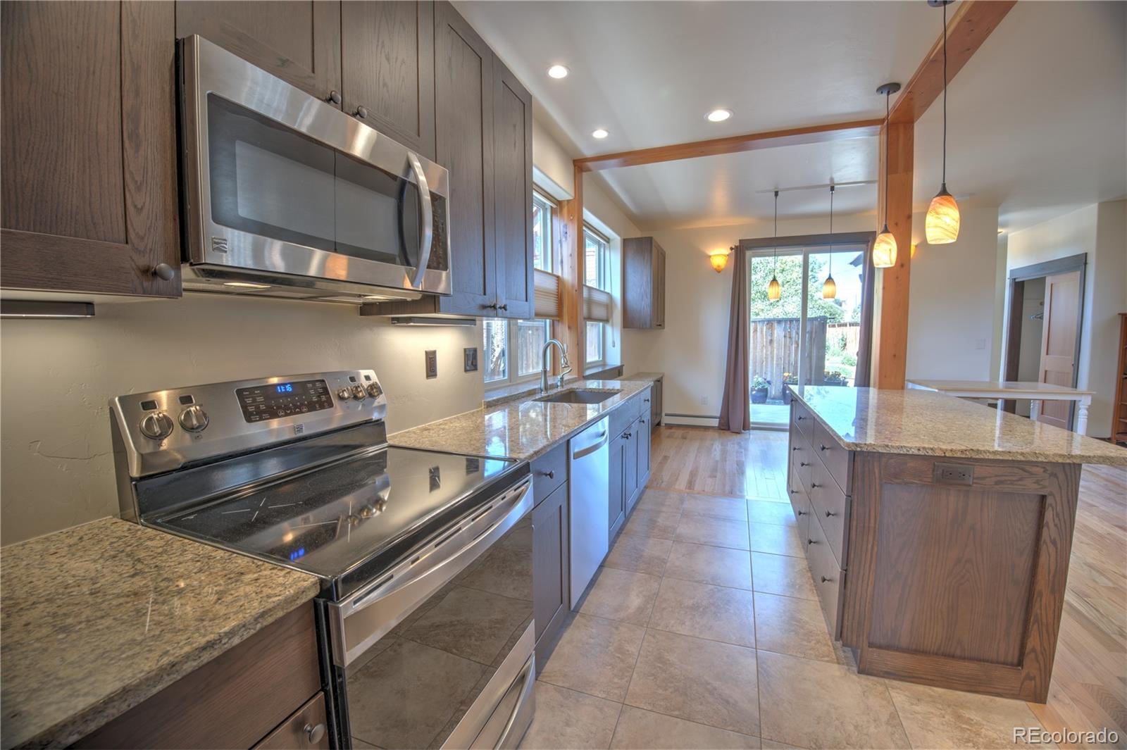315 G Street Salida, CO 81201 - Photo 3 of 43 a kitchen with stainless steel appliances granite countertop a stove a sink and a microwave