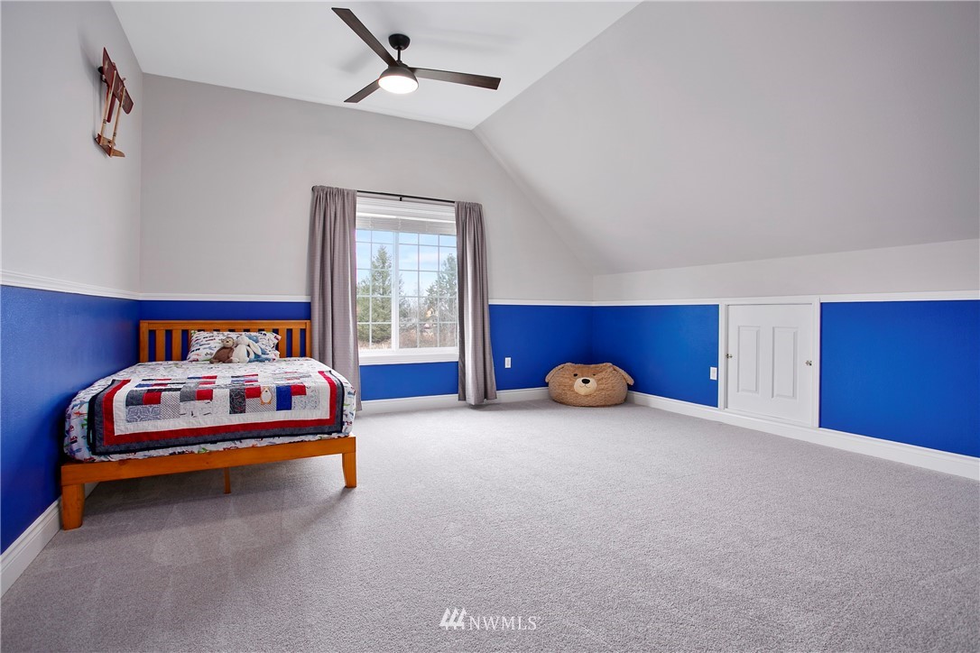 6580 Olson Road Ferndale, WA 98248 - Photo 30 of 38 a bedroom with a bed and a car