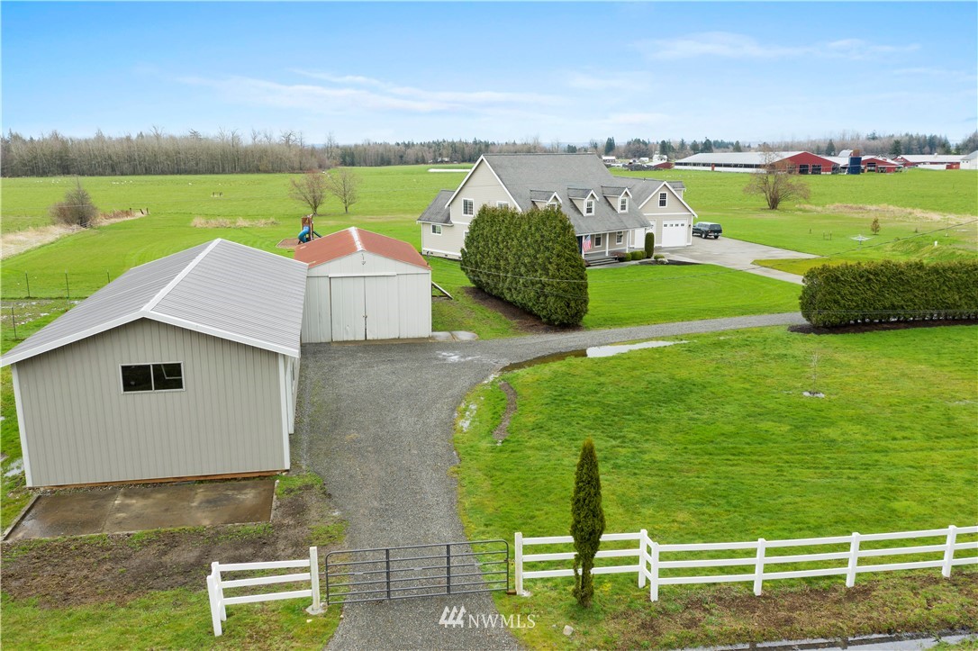 6580 Olson Road Ferndale, WA 98248 - Photo 3 of 38 an aerial view of a house with a garden and lake view