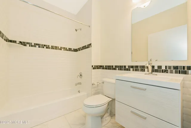 a bathroom with a toilet and a bathtub