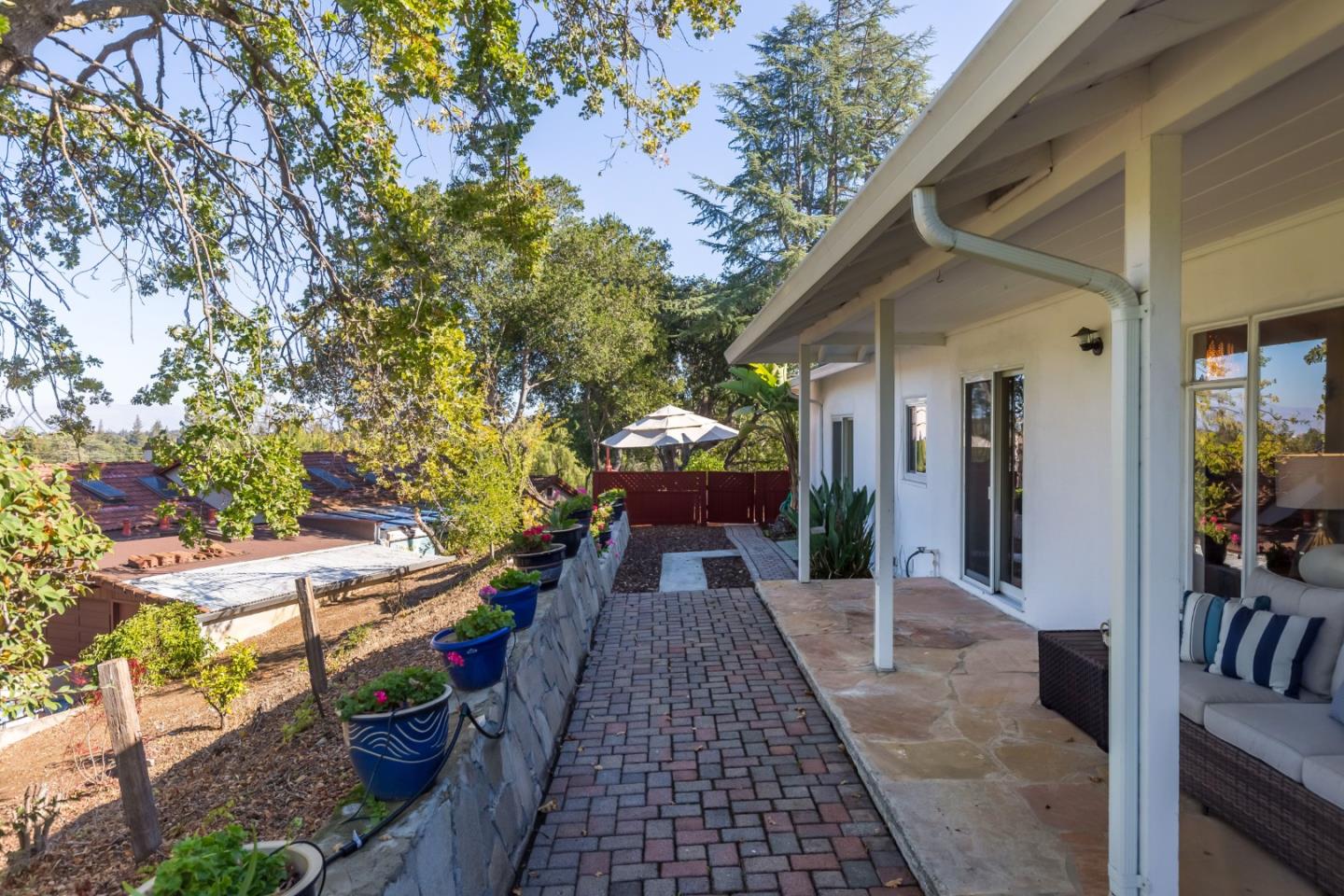525 Outlook Drive Los Altos, CA 94024 - Photo 19 of 34 a view of a patio with table and chairs potted plants with wooden floor