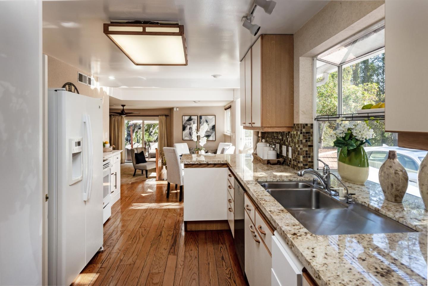 525 Outlook Drive Los Altos, CA 94024 - Photo 6 of 34 a kitchen with stainless steel appliances granite countertop a sink dishwasher stove and wooden floor
