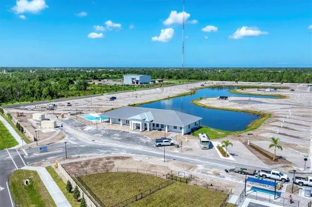 a view of a house with a yard and lake view
