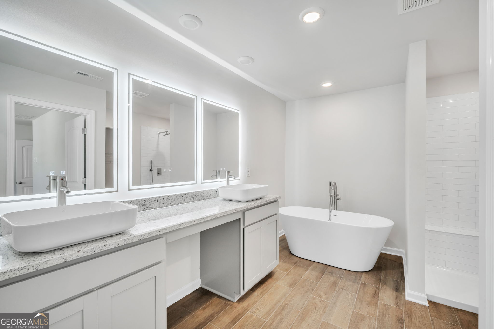 305 Rusty Plow Lane, Unit 13 Perry, GA 31069 - Photo 15 of 25 a spacious bathroom with a granite countertop sink and a large mirror