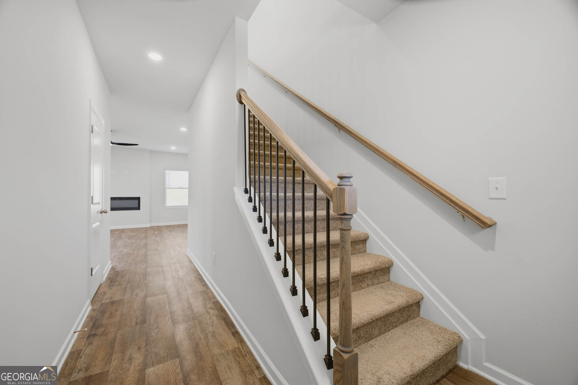 305 Rusty Plow Lane, Unit 13 Perry, GA 31069 - Photo 17 of 24 a view of a hallway with wooden floor and staircase