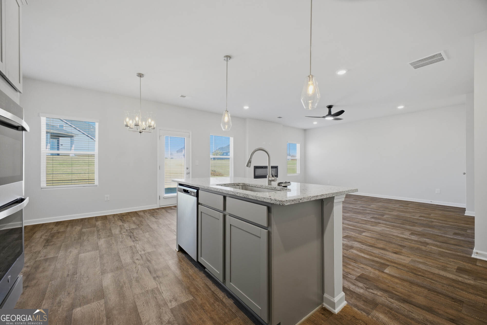 305 Rusty Plow Lane, Unit 13 Perry, GA 31069 - Photo 18 of 24 a kitchen with a sink cabinets and wooden floor