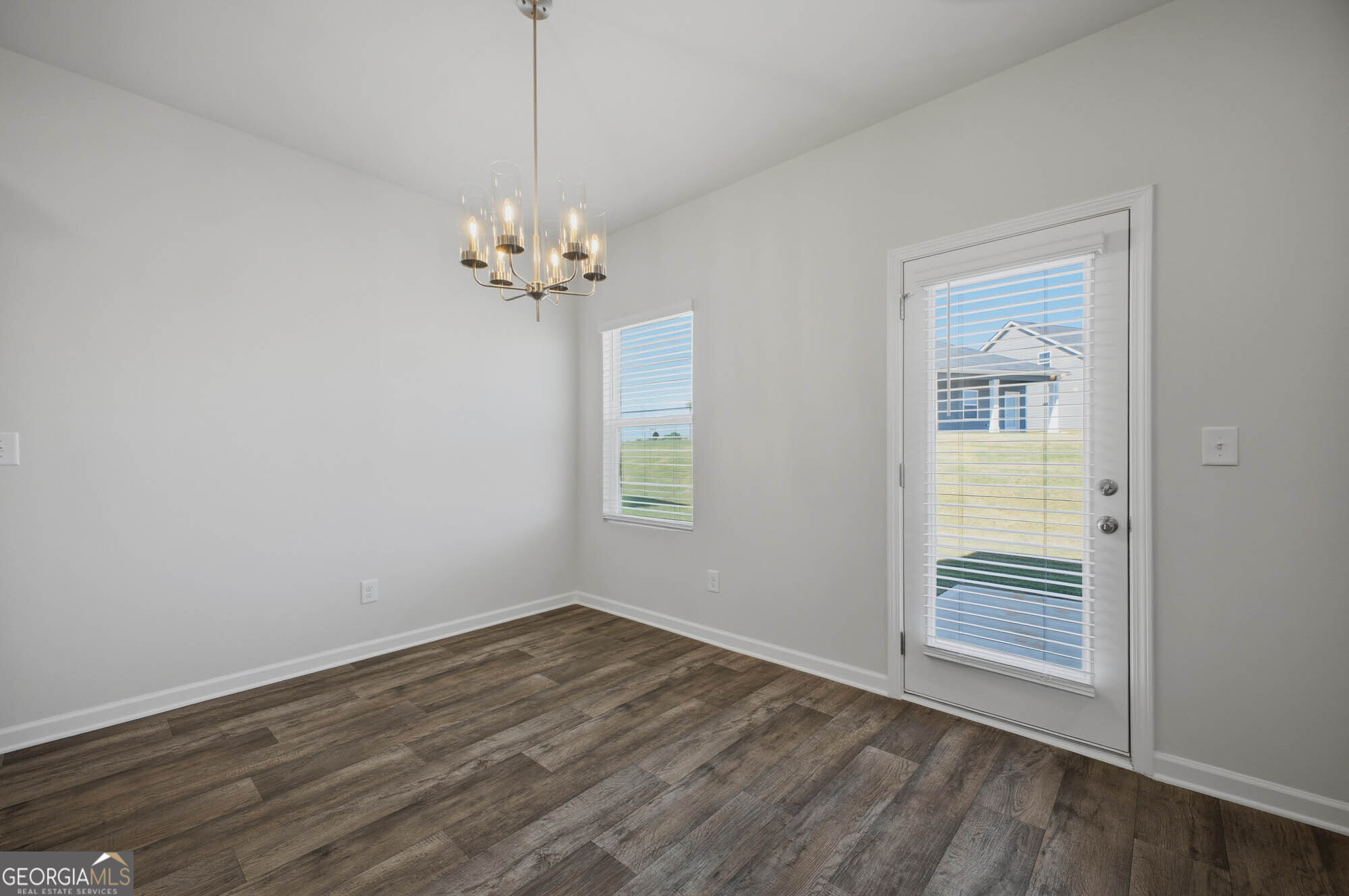 305 Rusty Plow Lane, Unit 13 Perry, GA 31069 - Photo 20 of 24 a view of a room with wooden floor chandelier and window