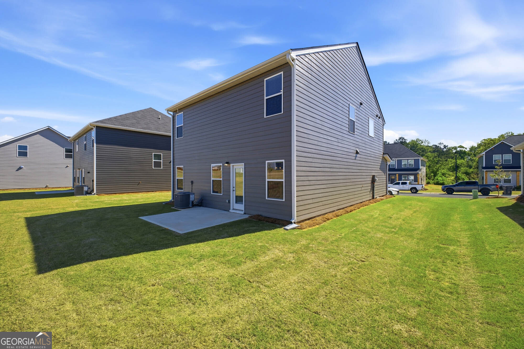 305 Rusty Plow Lane, Unit 13 Perry, GA 31069 - Photo 21 of 24 a yellow house with a yard and a small yard