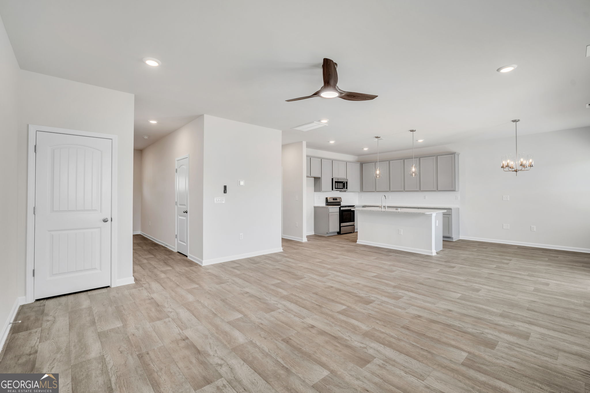 305 Rusty Plow Lane, Unit 13 Perry, GA 31069 - Photo 5 of 25 a view of a kitchen with a sink and a refrigerator