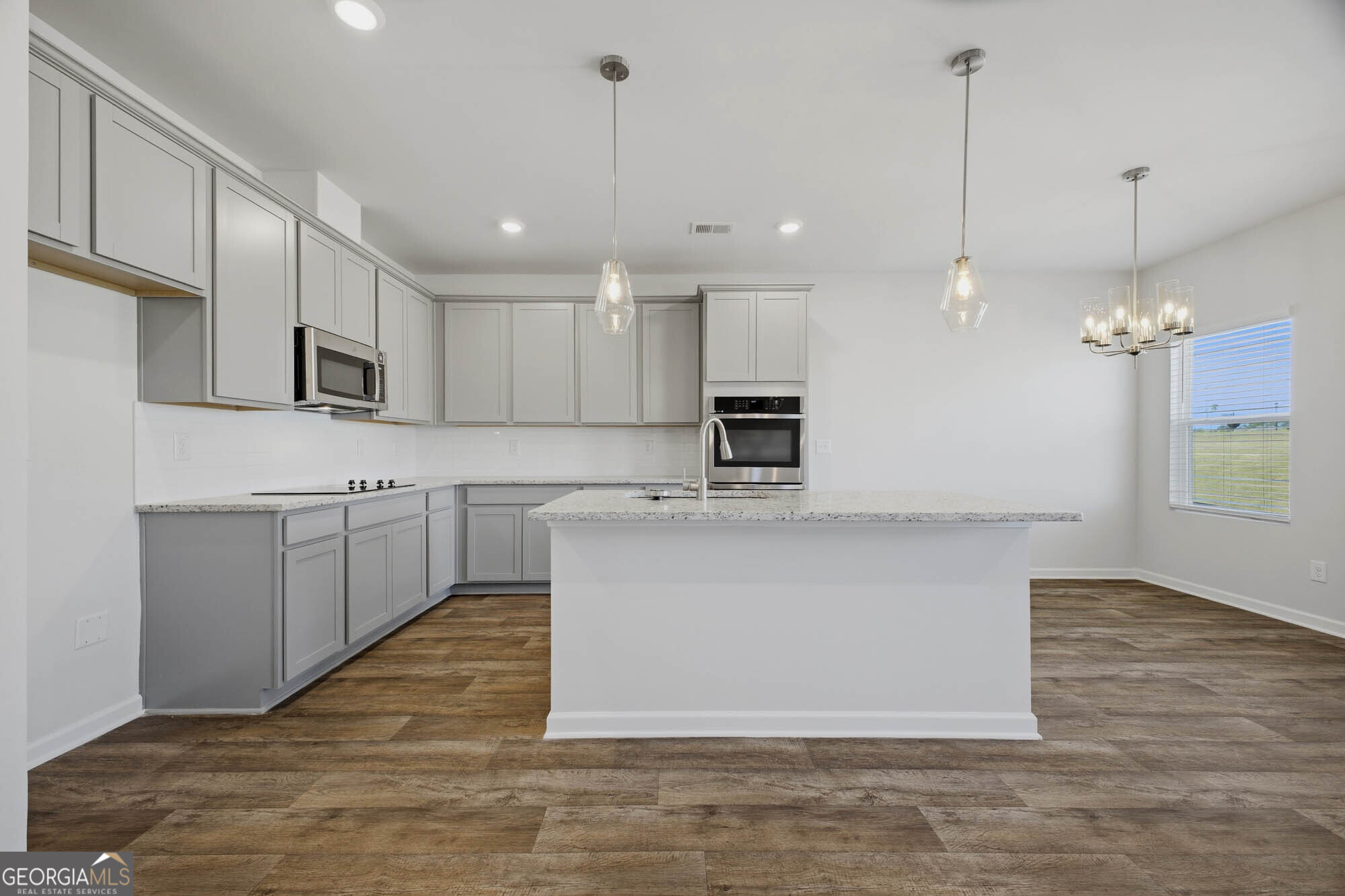 305 Rusty Plow Lane, Unit 13 Perry, GA 31069 - Photo 9 of 24 a large kitchen with stainless steel appliances kitchen island a cabinets and a counter top space