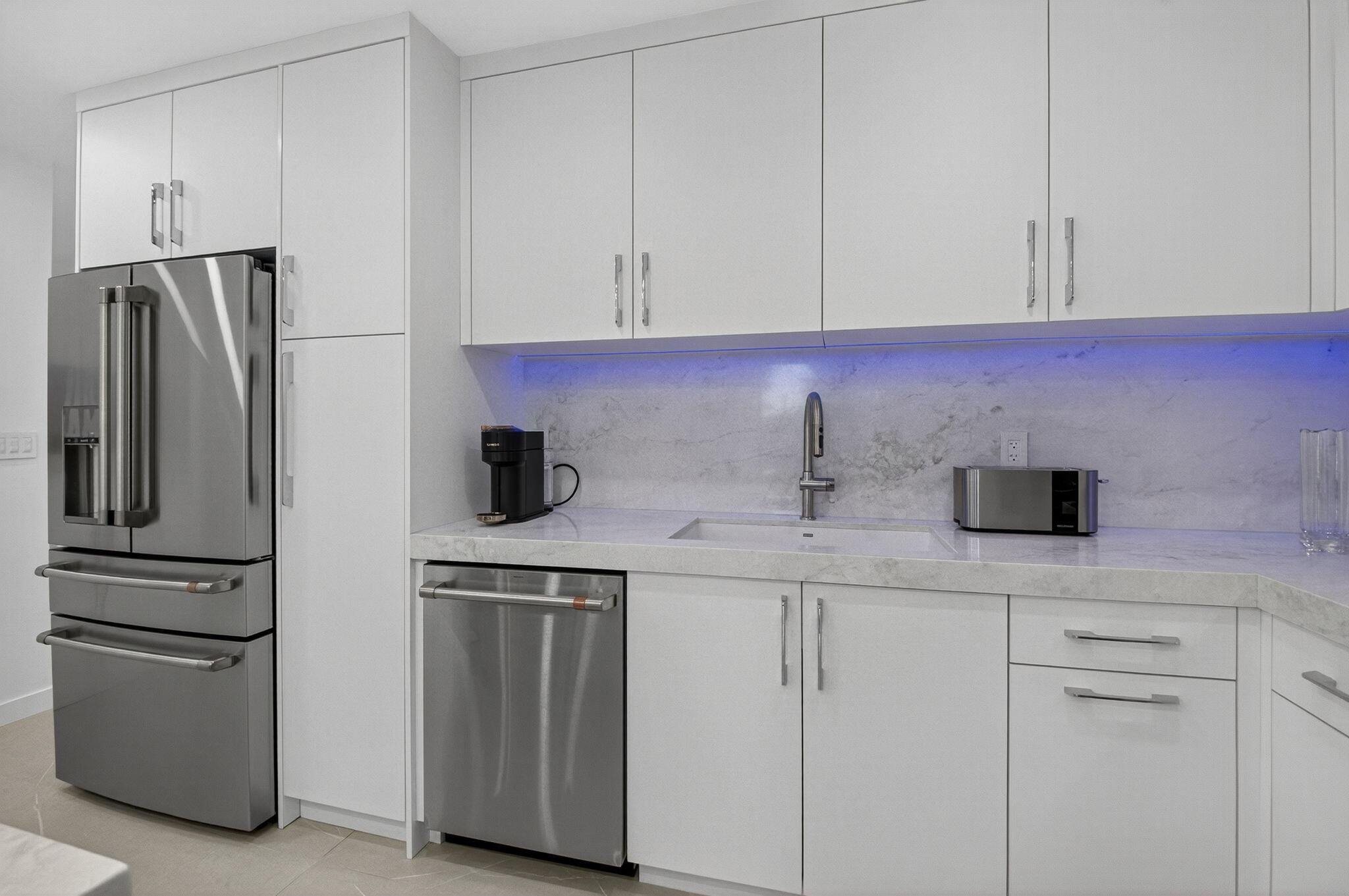 7847 Lakeside Boulevard, Unit 1014 Boca Raton, FL 33434 - Photo 11 of 53 a kitchen with stainless steel appliances white cabinets and a refrigerator