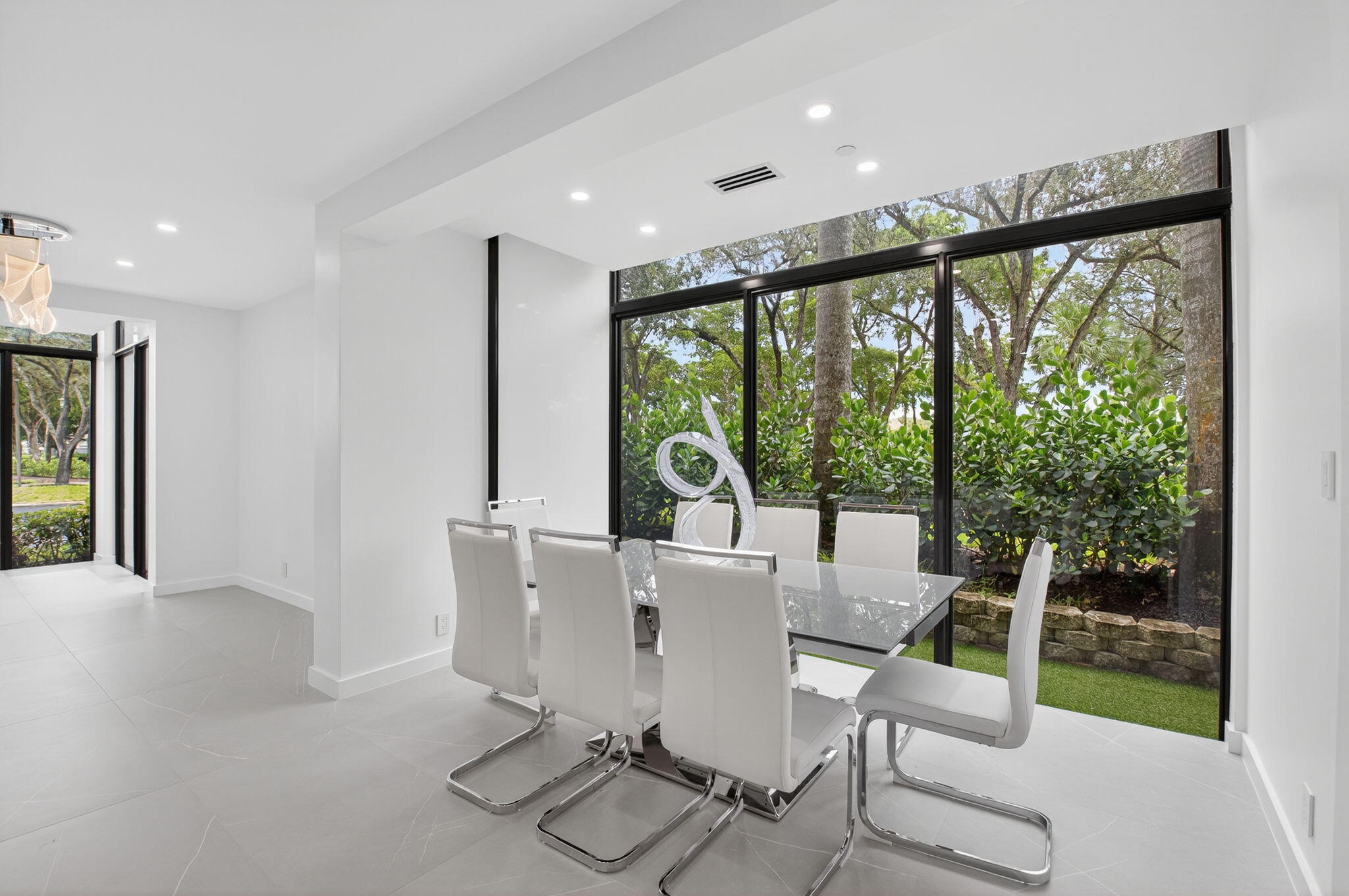 7847 Lakeside Boulevard, Unit 1014 Boca Raton, FL 33434 - Photo 16 of 53 a view of a dining room with furniture wooden floor and a floor to ceiling window