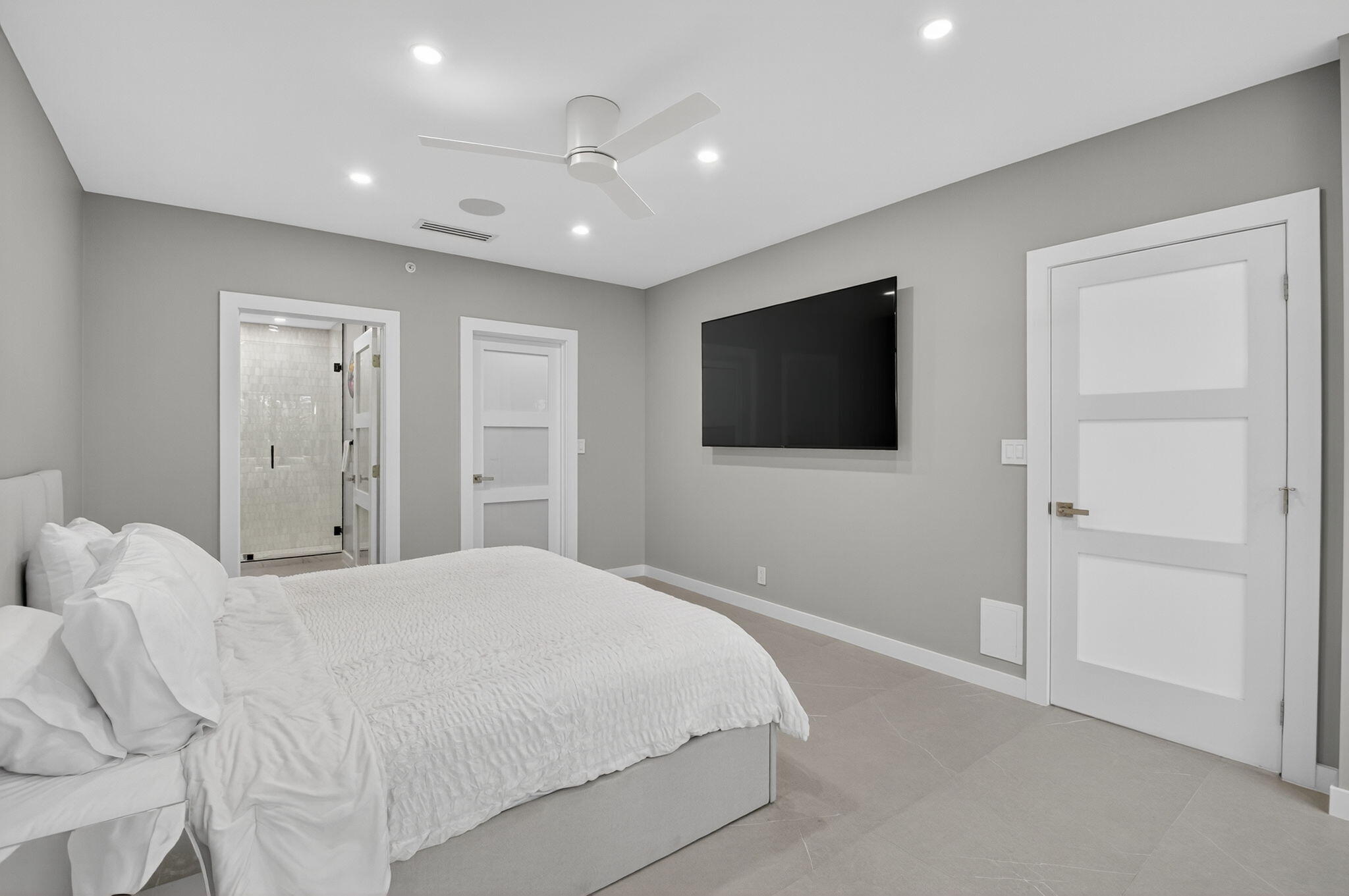 7847 Lakeside Boulevard, Unit 1014 Boca Raton, FL 33434 - Photo 21 of 53 a bedroom with a bed and a flat screen tv