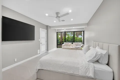 a bathroom with a granite countertop sink a toilet a mirror and shower
